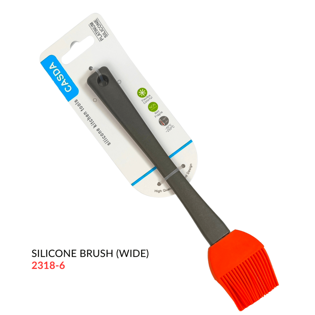 Wide silicone brush with a red head and black handle, presented on packaging.
