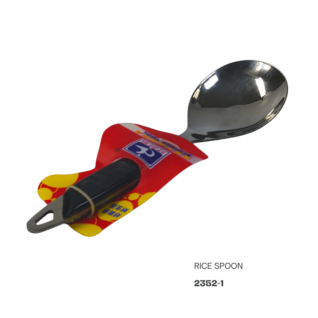 A stainless steel rice spoon in packaging, featuring a red and yellow design with a black handle.