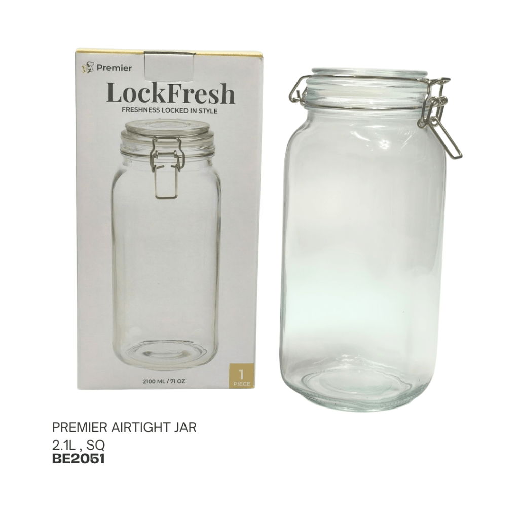 A Premier airtight jar with a capacity of 2.1 liters, displayed next to its packaging. The jar features a clear glass design and a metal locking mechanism for freshness.