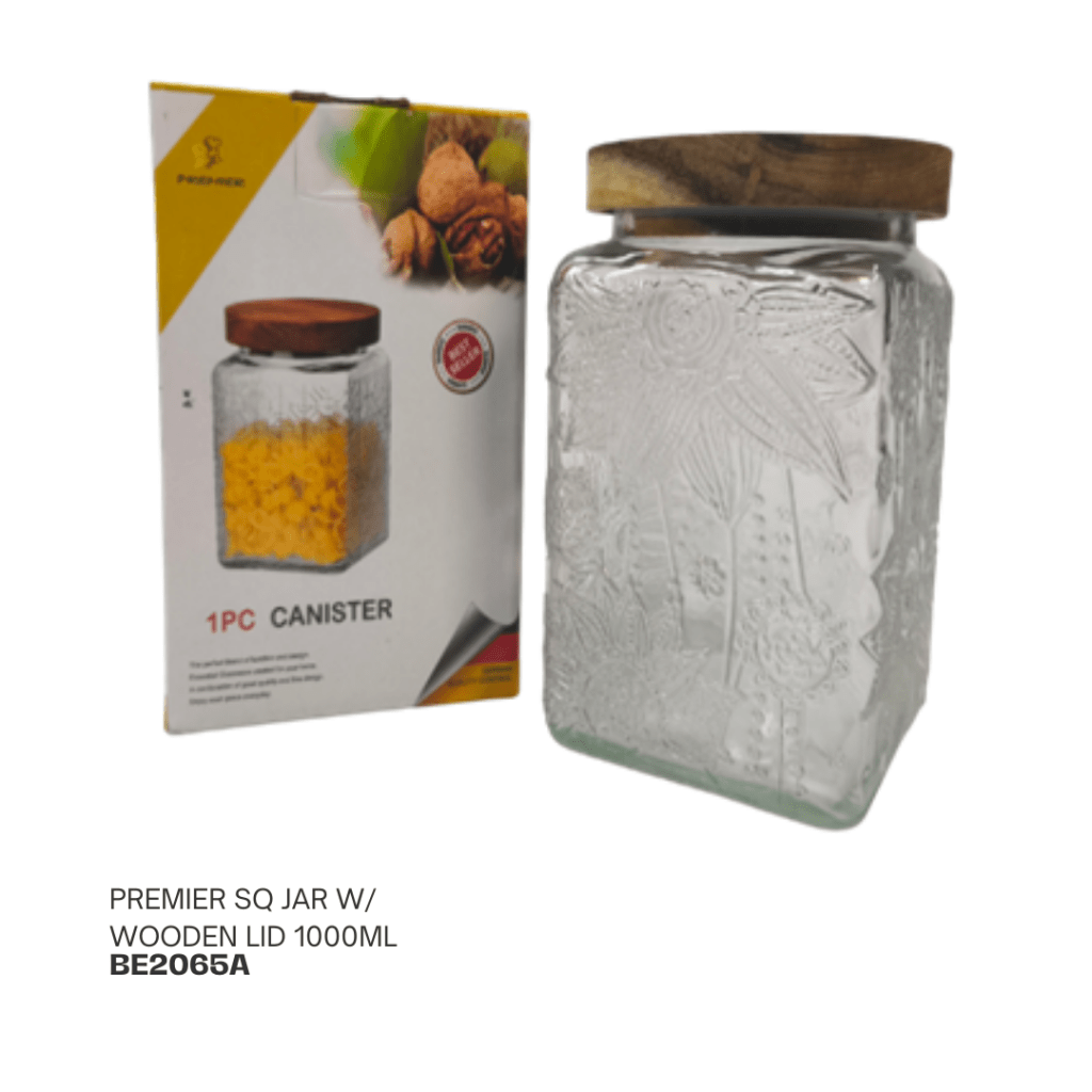 A clear glass square canister with a wooden lid, featuring floral designs on the sides, beside its packaging showing the product details.