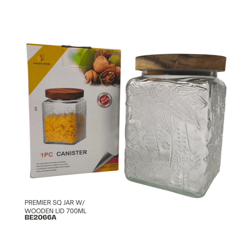 A 700ml square glass jar with a wooden lid, displayed next to its packaging, which features floral designs. The jar is embossed with decorative patterns and is intended for storage.
