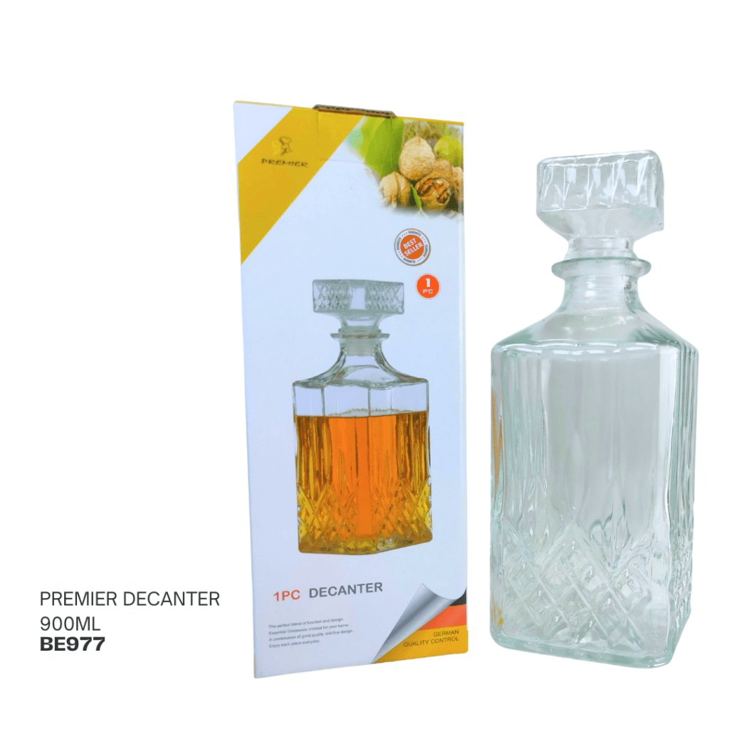A Premier decanter with a 900ml capacity, showcasing a stylish design and an amber liquid inside, displayed next to its packaging.